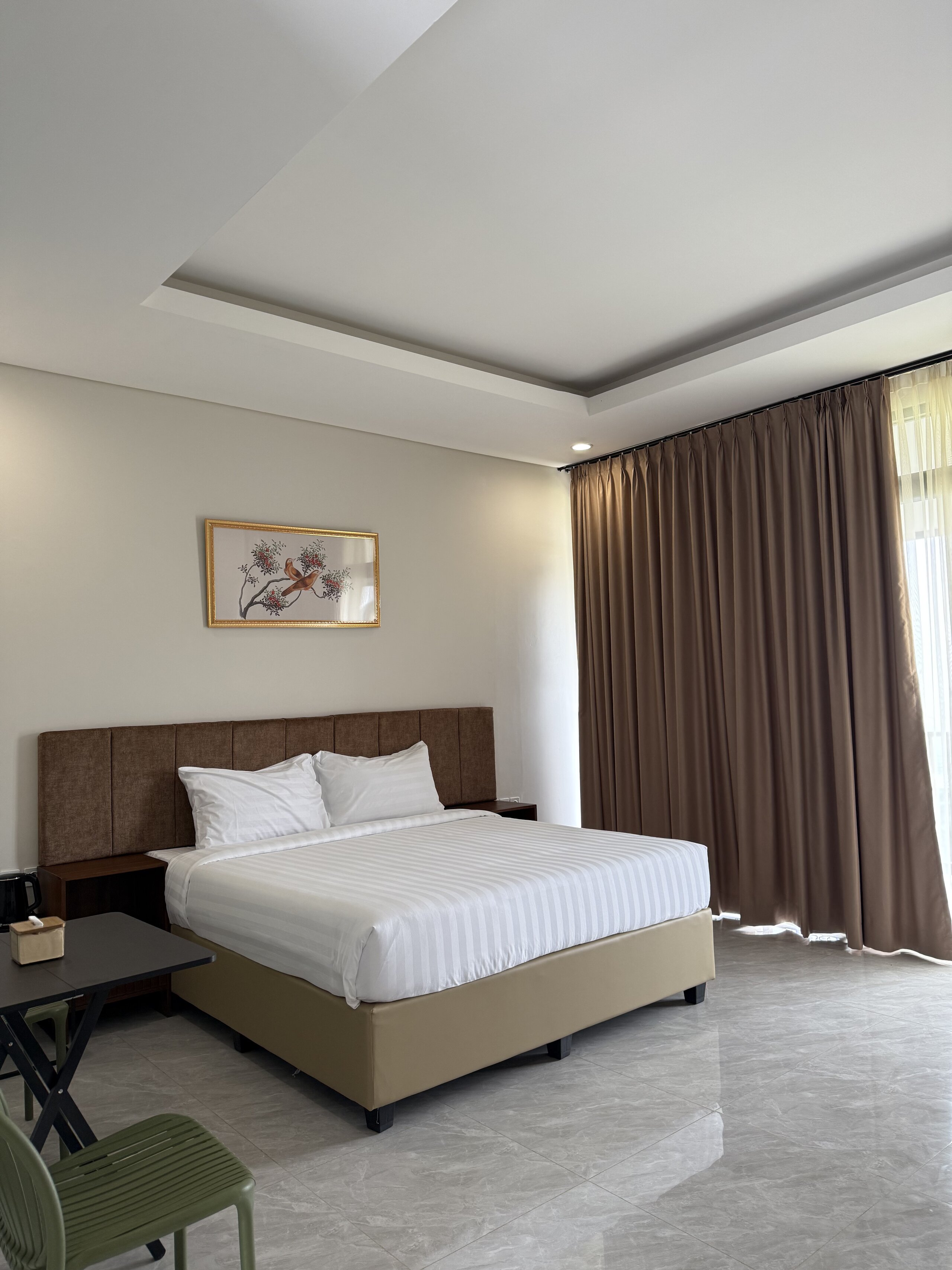 Spacious room with comfortable seating area and city views