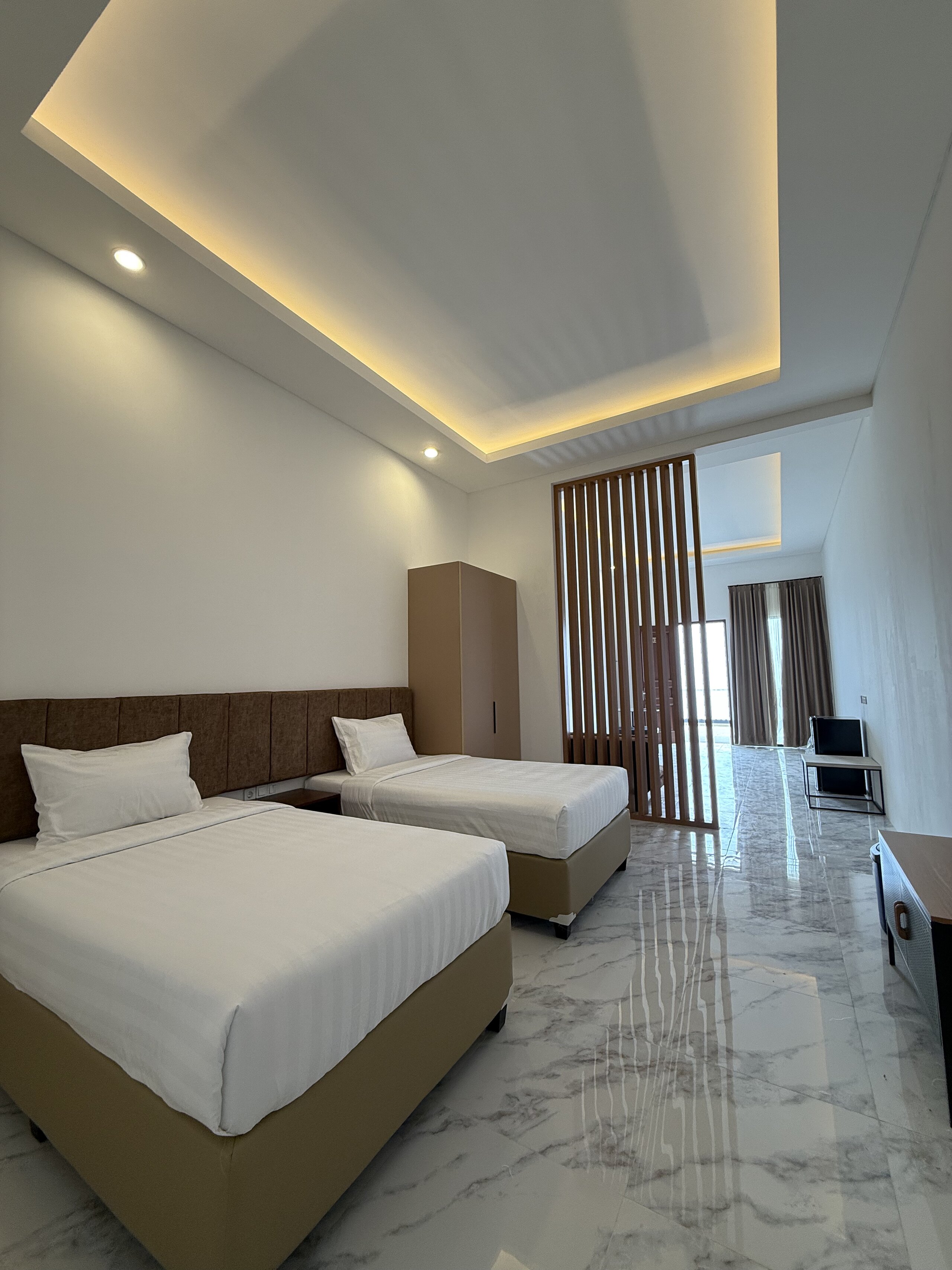 Spacious Suite bedroom with elegant decor and comfortable bedding